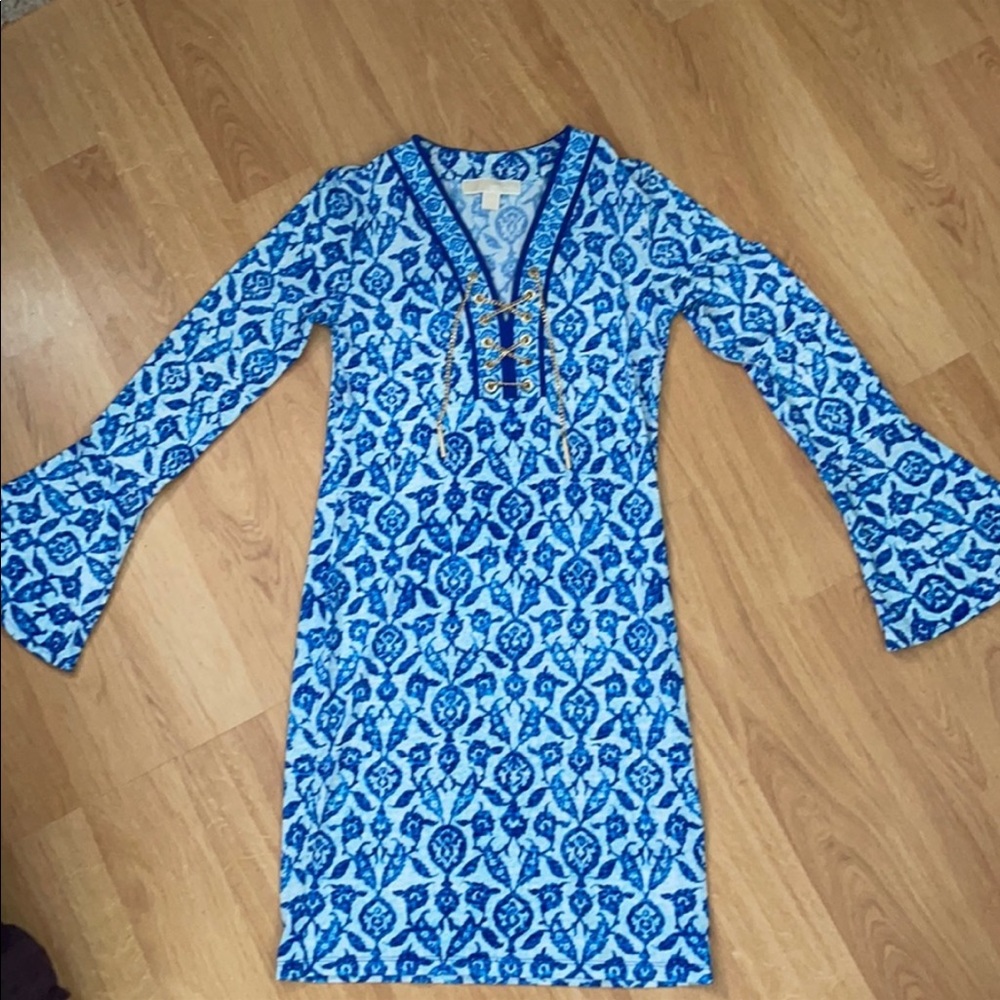 Michael Kors blue print dress with gold chain adornment.